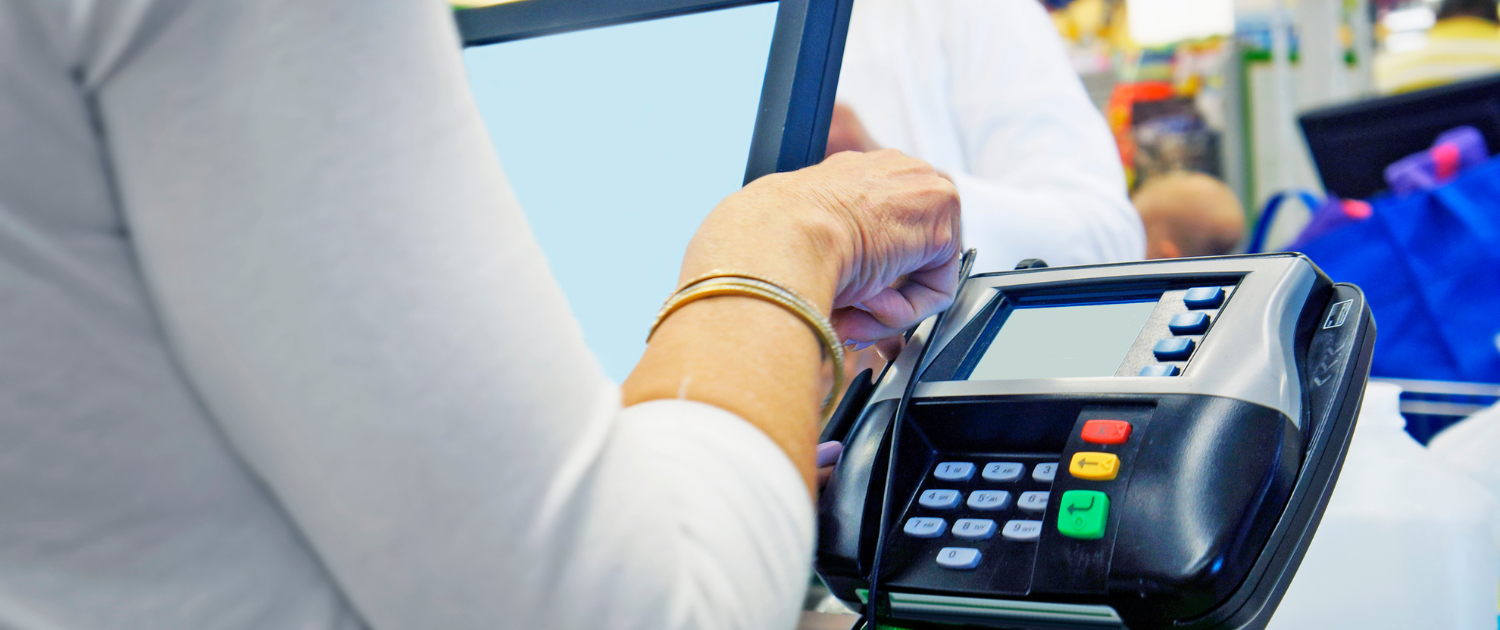 A person using a credit card machine

Description automatically generated