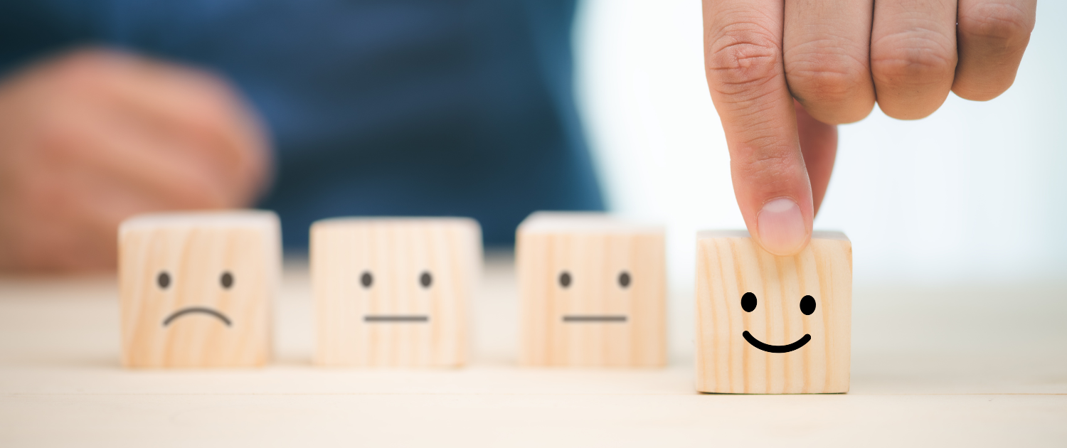 A finger touching a wooden block with smiley face and a smiley face

AI-generated content may be incorrect., Picture