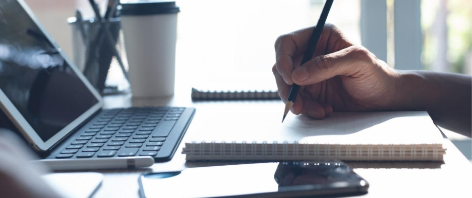 A hand holding a pencil and writing on a notebook

AI-generated content may be incorrect.