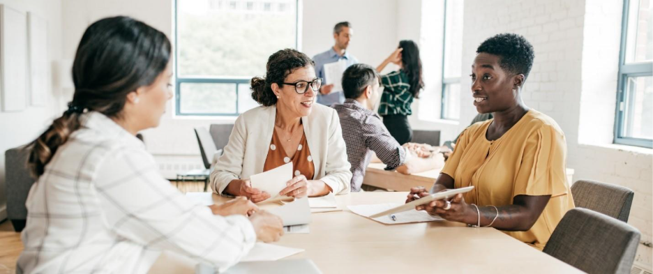 A group of people sitting at a table

AI-generated content may be incorrect.